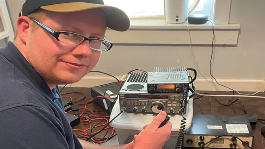 Campbell Reed, KD9GEK, seated at an amateur radio station